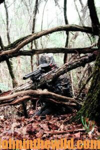 A hunter waits in the woods for a gobbler to approach shooting range