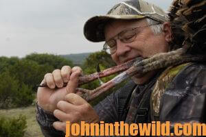 A hunter carries his downed gobbler