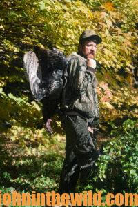 A hunter retrieves his downed turkey