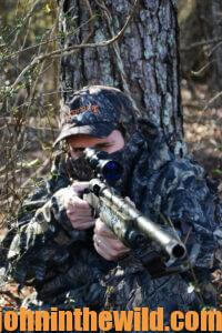 A hunter watches for a gobbler through his rifle scope