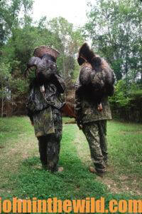 Two hunters retrieve their downed gobblers