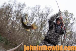 A fisherman reels in a fish