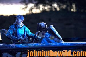 A fisherman out in his boat at night