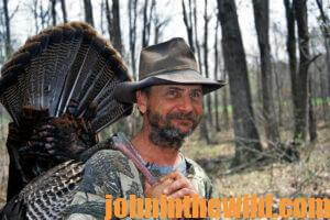 A hunter retrieves his downed gobbler