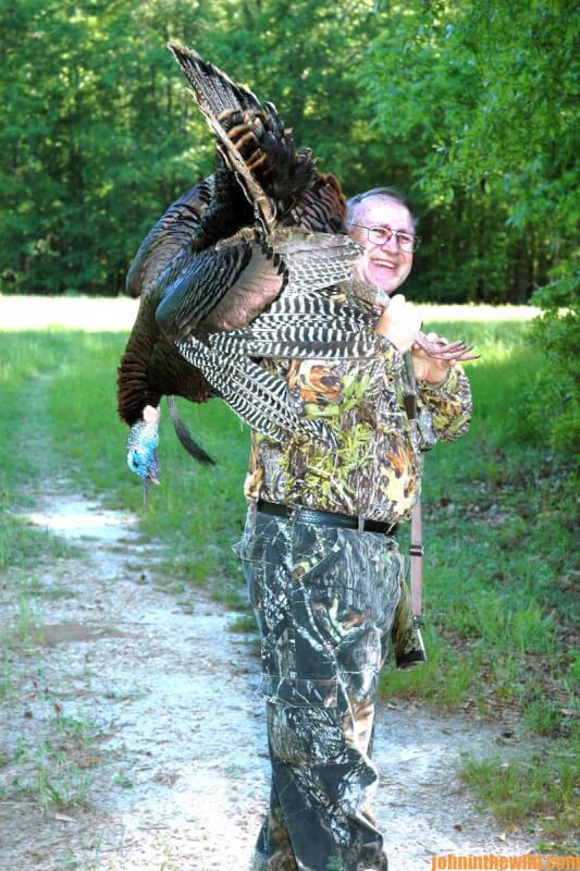 A hunter with his downed gobbler