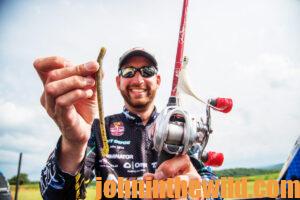 An angler shows the worm bait he's using