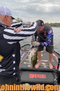 Ott DeFoe and a judge measure a fish