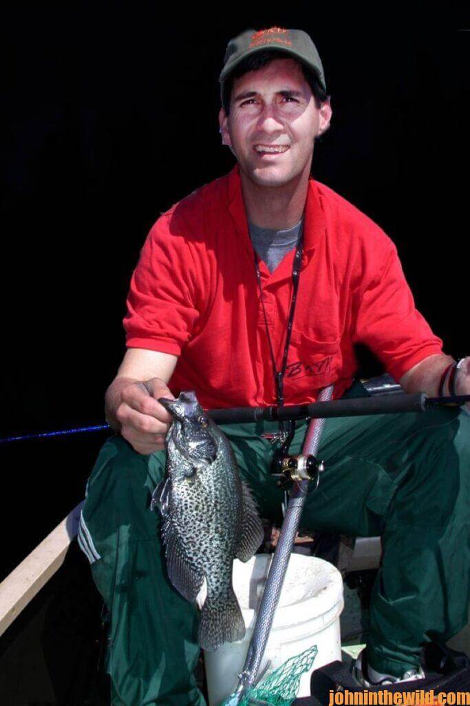 Fisherman poses with a crappie he caught at night