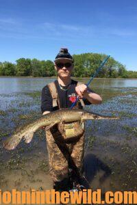 A bowfisherman shows off his catch