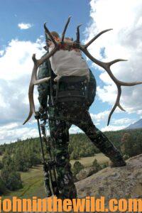 Elk hunter, Eddie Salter, overlooking the land at the bottom of a hill.
