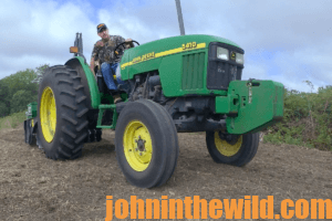 A hunter poses for a picture on his tractor