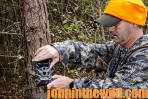 A hunter checks his trail cameras