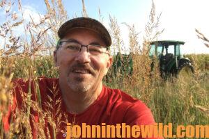 A hunter smiles for a photo in a field