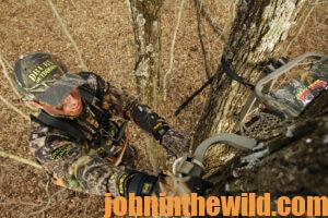 a hunter setting up his tree stand
