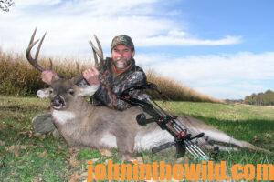 A hunter with his downed deer