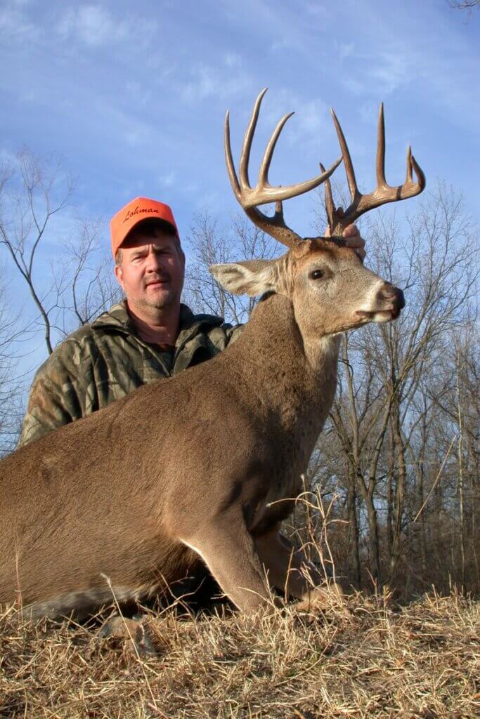 A hunter and his trophy buck