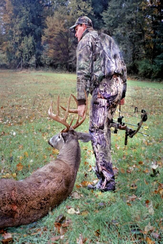 A hunter and his trophy buck