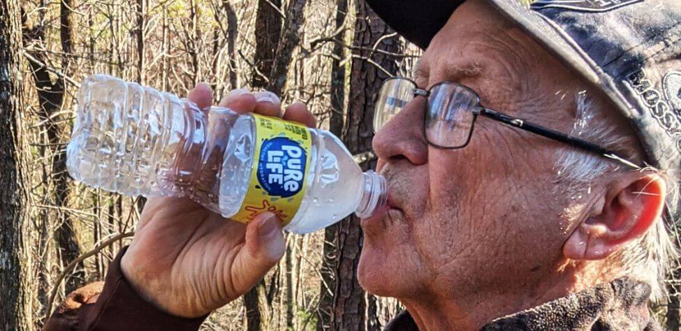 John Phillips drinking water while hunting