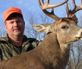 Deer hunter with his trophy.
