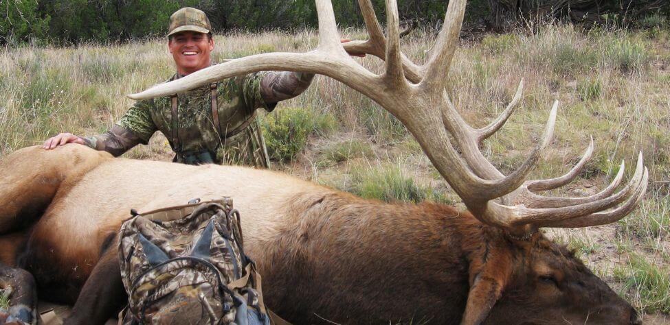 Elk hunter with his trophy elk